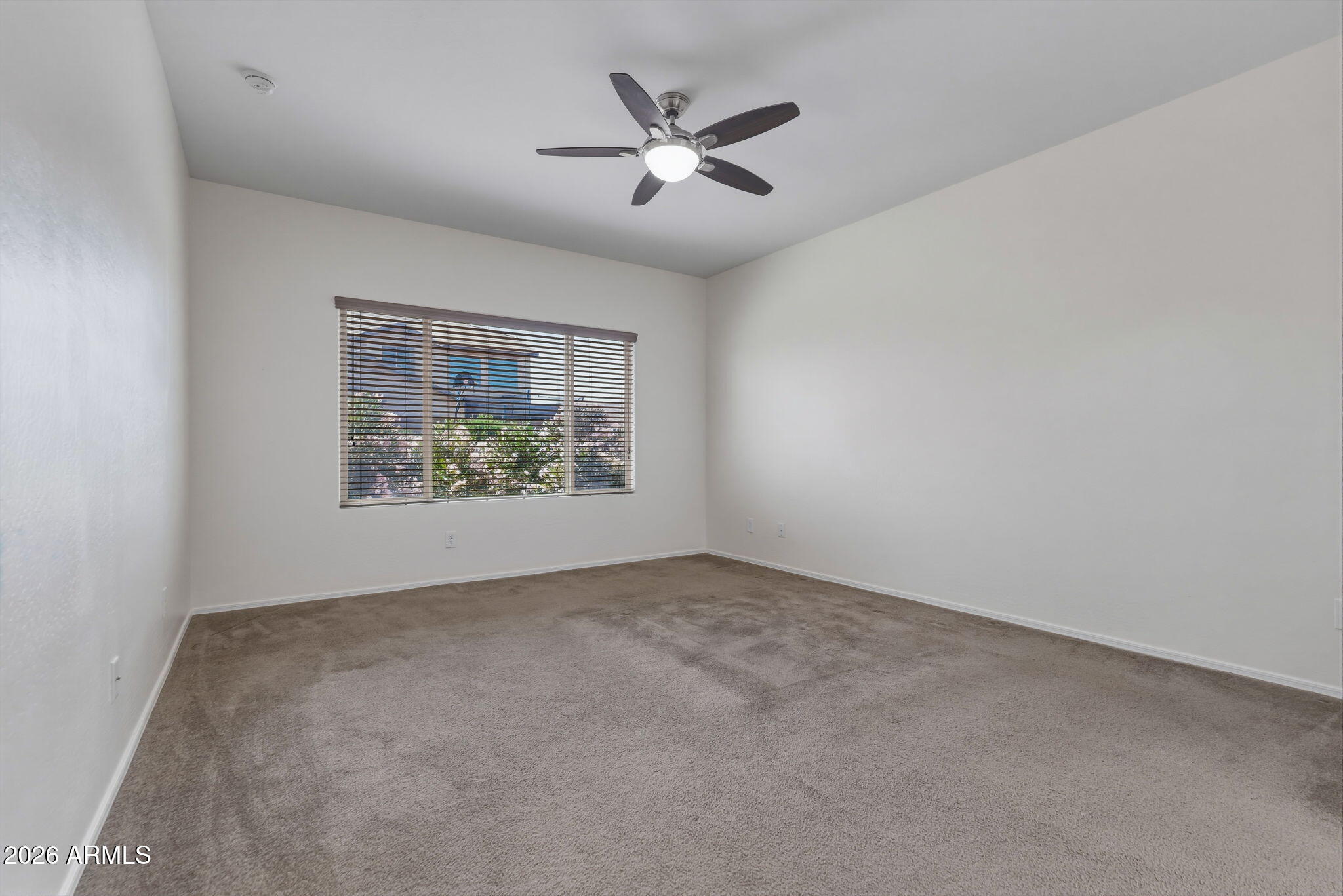 17543 West Buckhorn Trail Surprise, AZ 85387 - Photo 28 of 104 an empty room with ceiling fan and window