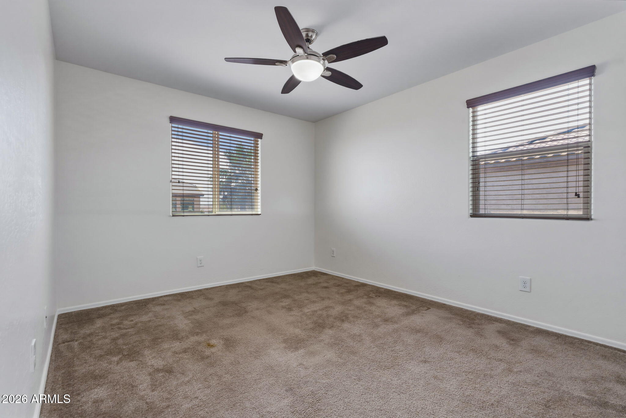 17543 West Buckhorn Trail Surprise, AZ 85387 - Photo 49 of 104 an empty room with a window and a ceiling fan