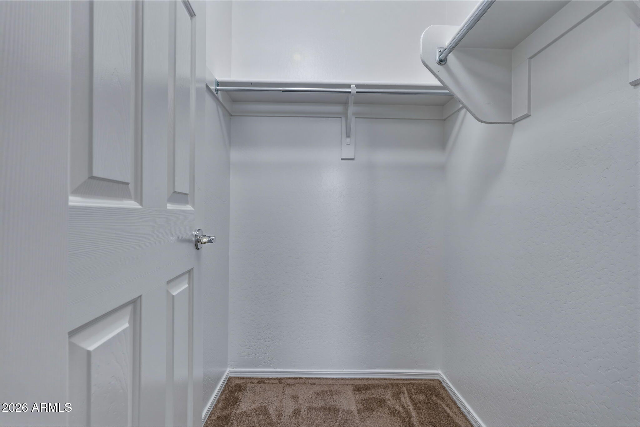 17543 West Buckhorn Trail Surprise, AZ 85387 - Photo 52 of 104 a view of walk in closet with empty racks