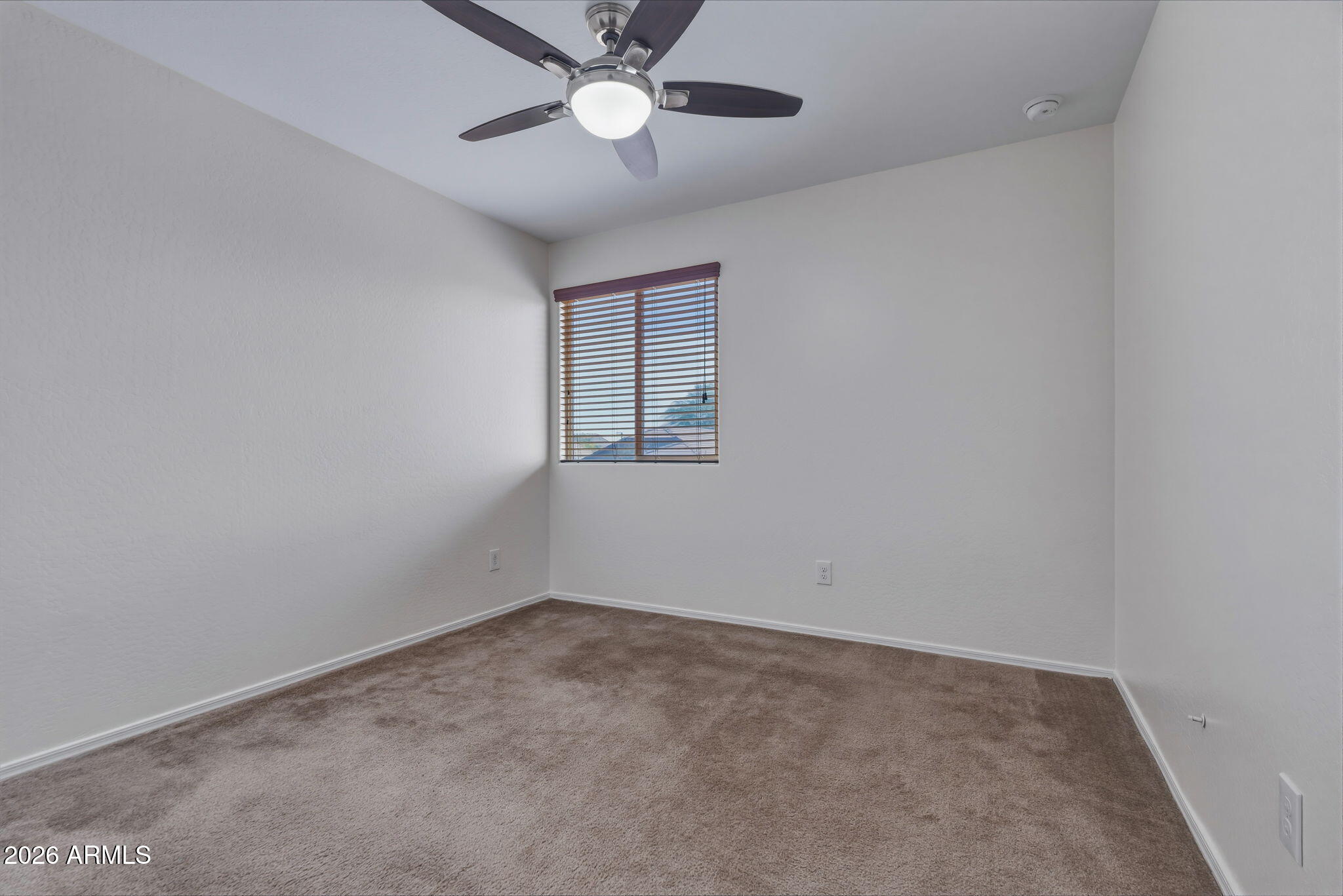 17543 West Buckhorn Trail Surprise, AZ 85387 - Photo 53 of 104 an empty room with a window and ceiling fan