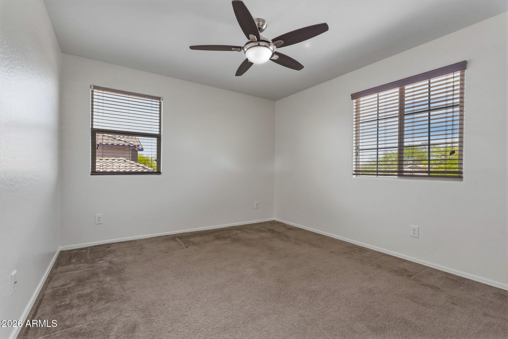 17543 West Buckhorn Trail Surprise, AZ 85387 - Photo 56 of 104 an empty room with a window and a ceiling fan