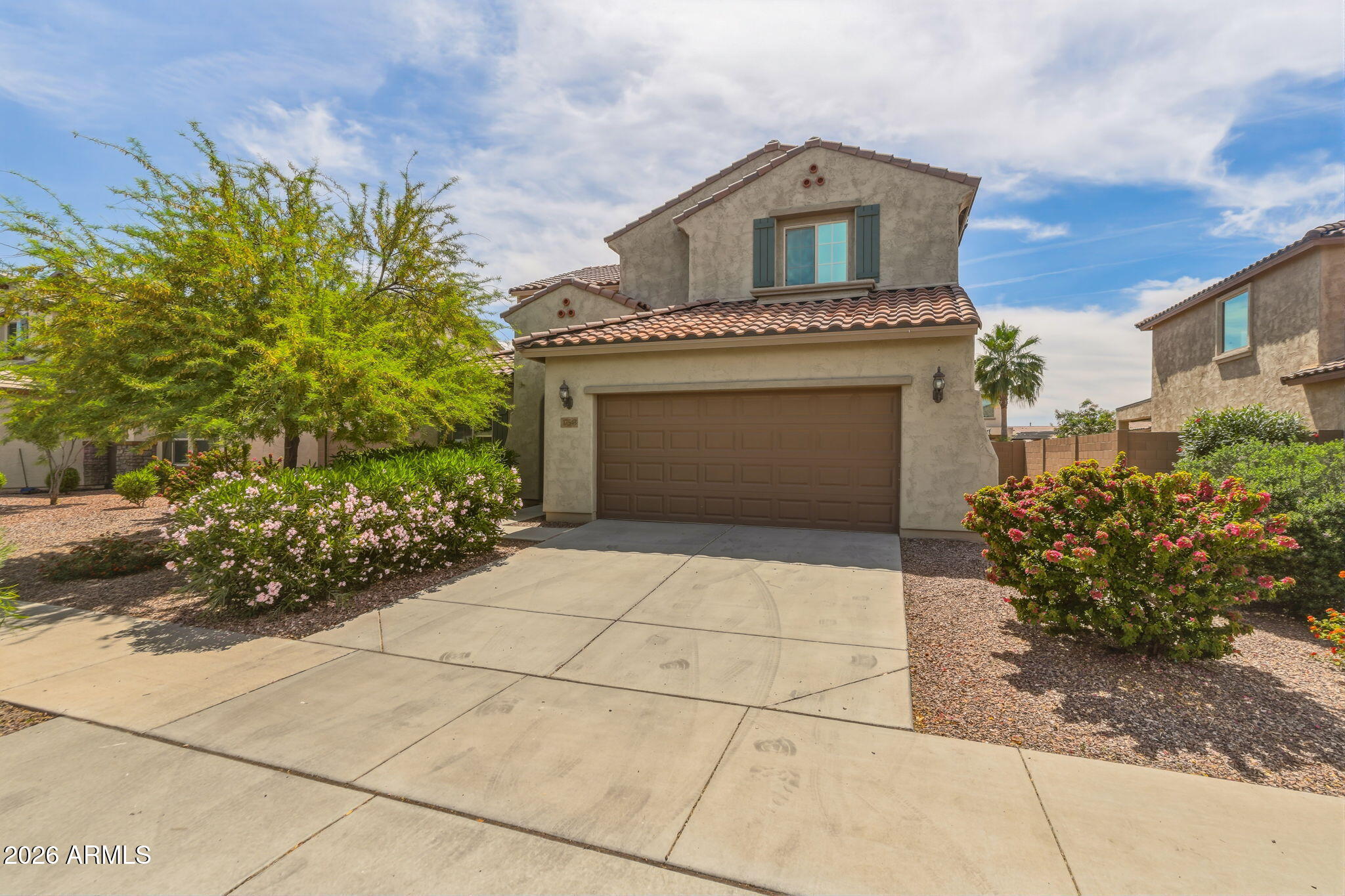 17543 West Buckhorn Trail Surprise, AZ 85387 - Photo 4 of 104 a front view of a house with a garden