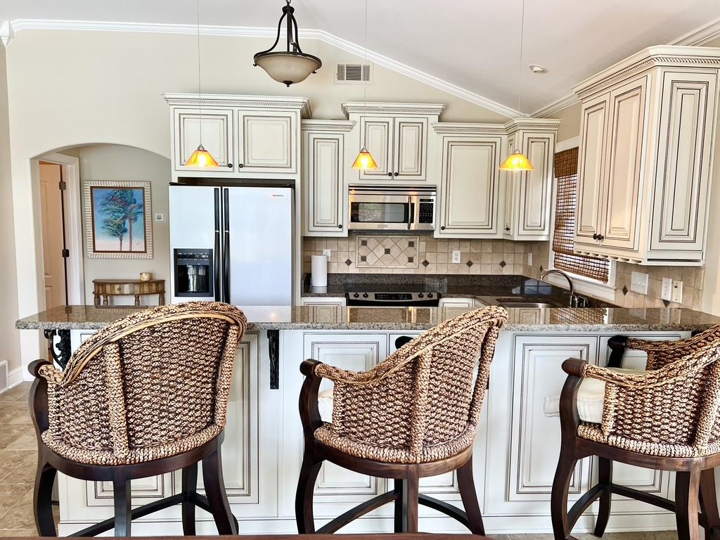 630 Ridge Springs Road Collierville, TN 38017 - Photo 7 of 24 a kitchen with stainless steel appliances granite countertop a sink a stove a dining table and chairs