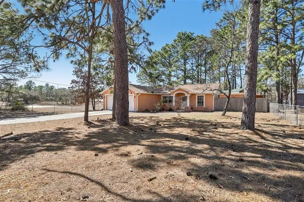 a view of a house with a yard covered in snow