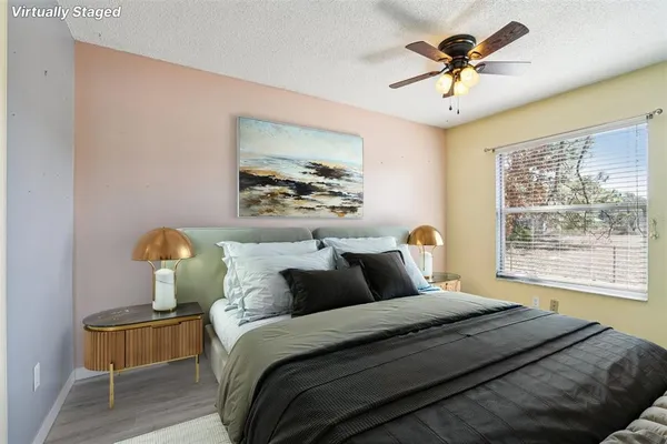a bedroom with a bed and a painting on the wall