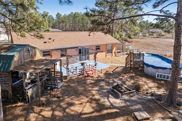 a view of a house with backyard and sitting area