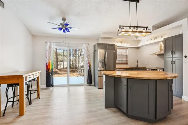 a kitchen with stainless steel appliances granite countertop a stove and cabinets