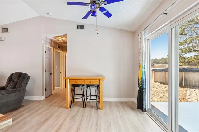 a dining room with furniture and wooden floor