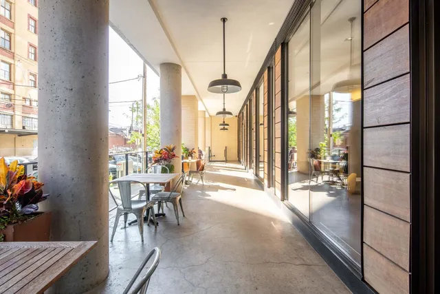 a dining room with furniture water view and a floor to ceiling window