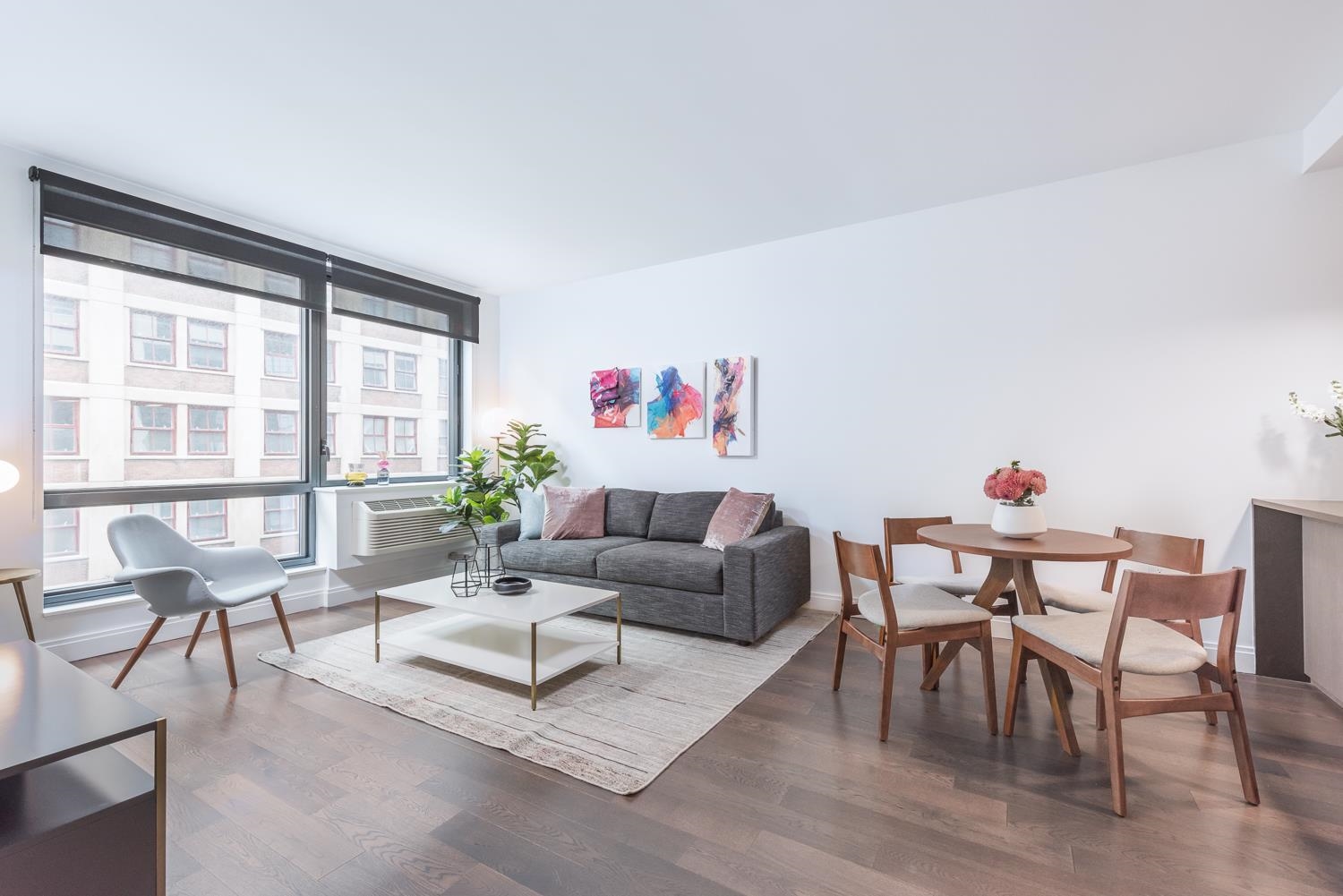 148 1st Street, Unit 809 Jersey City, NJ 07302 - Photo 17 of 20 a living room with furniture and a large window