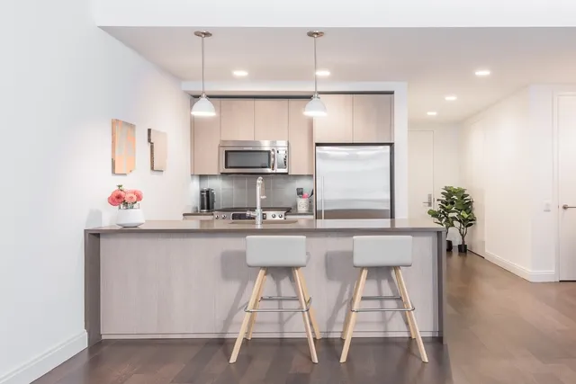 a kitchen with stainless steel appliances a sink and a refrigerator