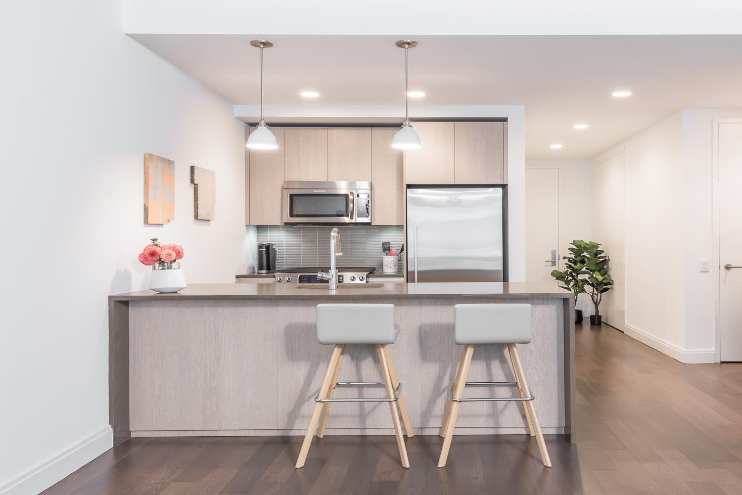 148 1st Street, Unit 809 Jersey City, NJ 07302 - Photo 18 of 20 a kitchen with stainless steel appliances a sink and a refrigerator