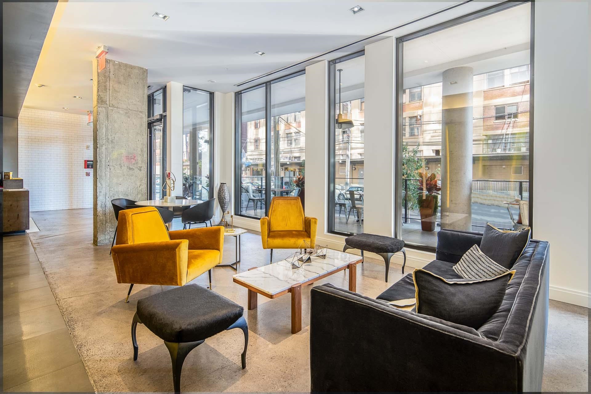 148 1st Street, Unit 809 Jersey City, NJ 07302 - Photo 2 of 20 a living room with furniture and a large window