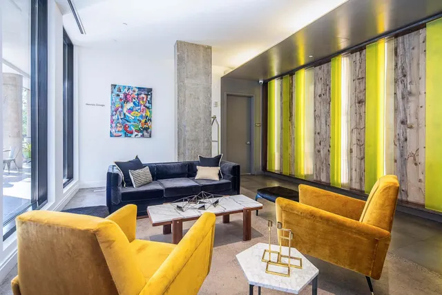 a living room with furniture and large windows