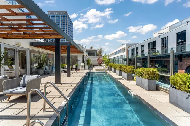 a view of a swimming pool with outdoor seating