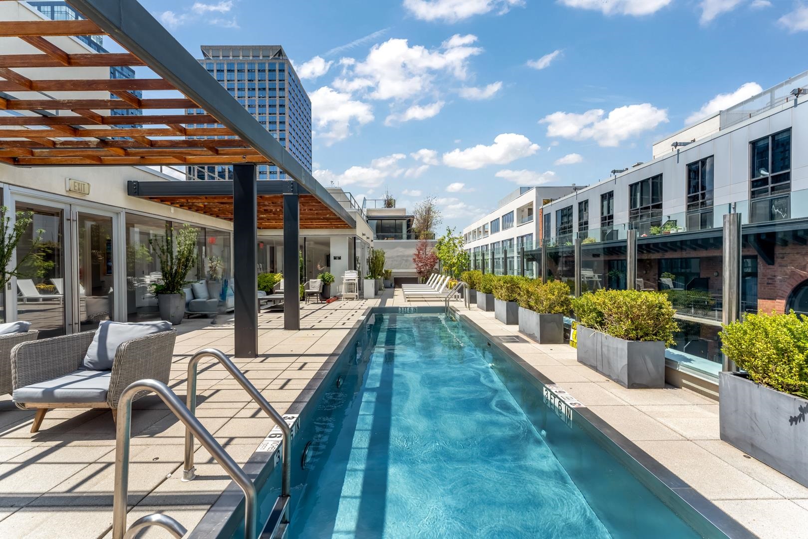 148 1st Street, Unit 809 Jersey City, NJ 07302 - Photo 4 of 20 a view of a swimming pool with outdoor seating