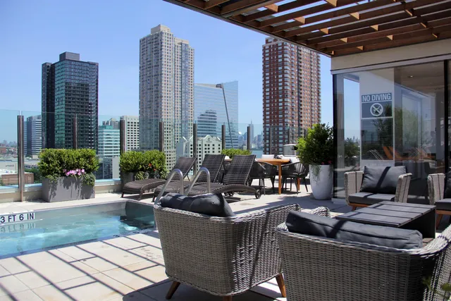 a living room with patio furniture and potted plants