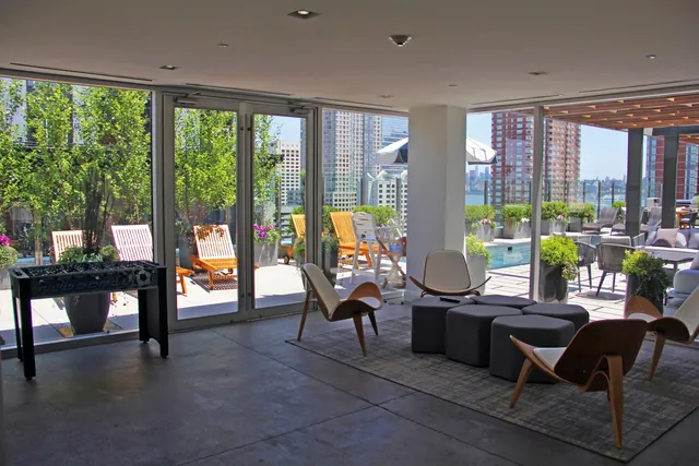 a living room with furniture and floor to ceiling windows
