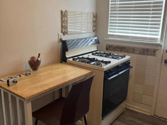 a stove top oven sitting inside of a kitchen