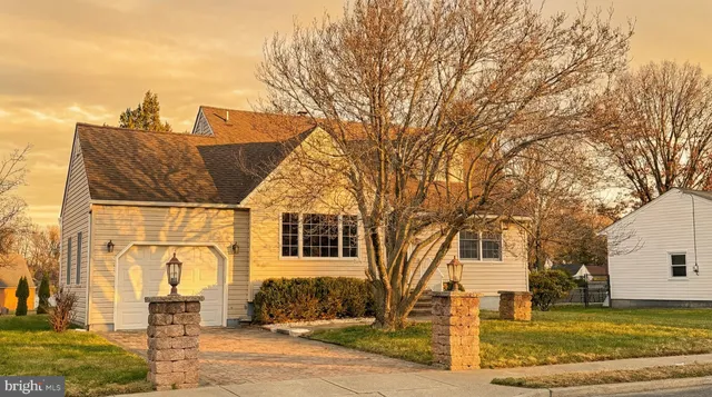 a view of a house with a yard covered in snow