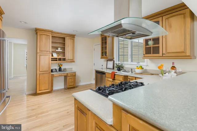 a kitchen with stainless steel appliances granite countertop a sink and a stove