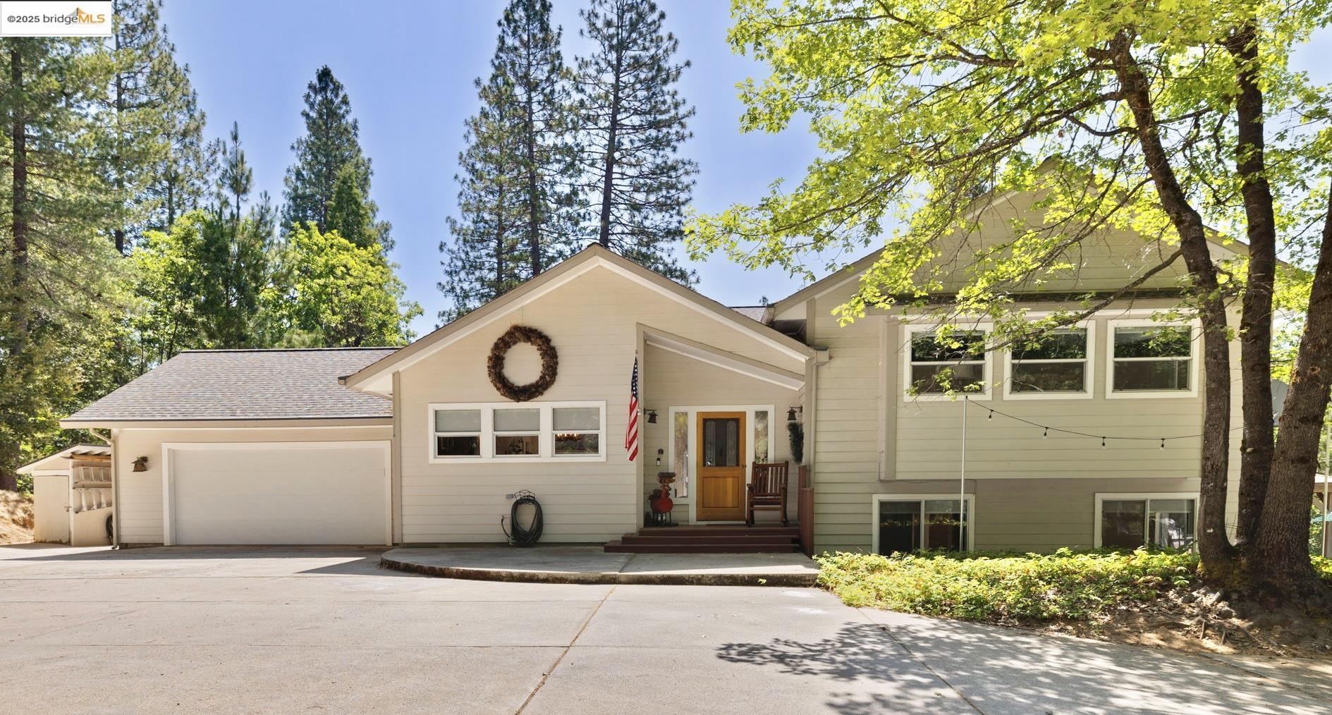 18080 Little Fuller Road Twain Harte, CA 95383 - Photo 1 of 40 View of front facade featuring concrete driveway, an attached garage, and roof with shingles