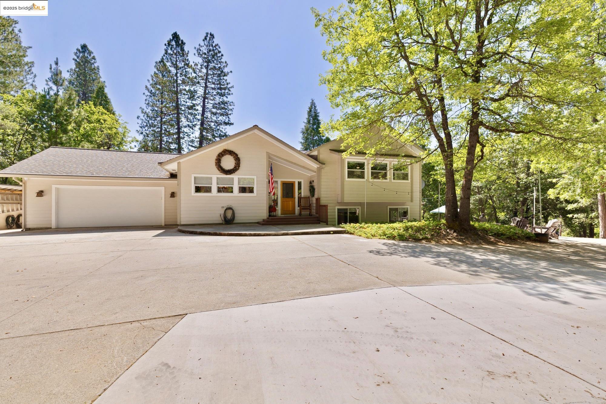 18080 Little Fuller Road Twain Harte, CA 95383 - Photo 2 of 40 Split foyer home featuring concrete driveway, a garage, and a shingled roof