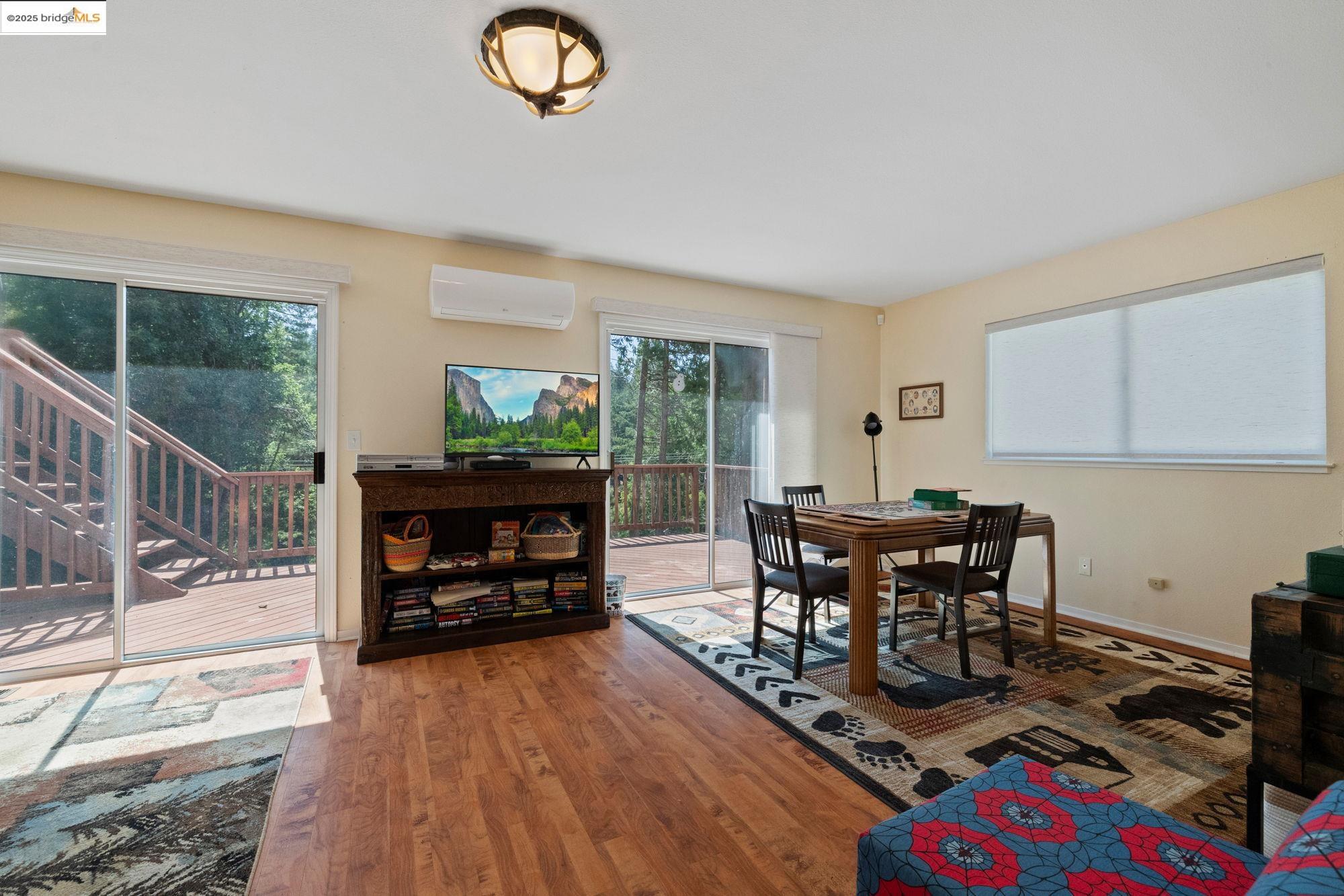 18080 Little Fuller Road Twain Harte, CA 95383 - Photo 27 of 40 Dining space with healthy amount of natural light, wood finished floors, and an AC wall unit