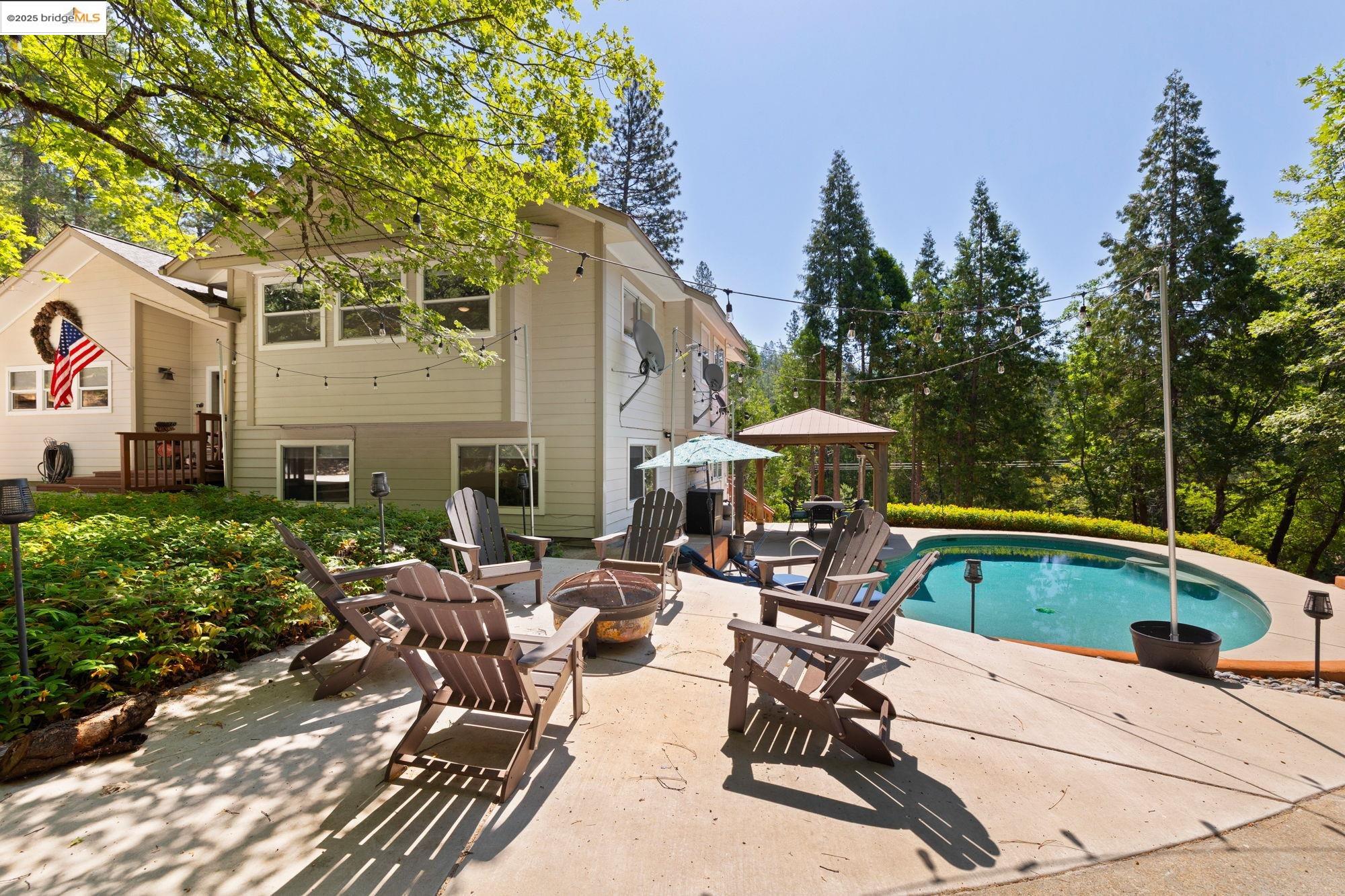 18080 Little Fuller Road Twain Harte, CA 95383 - Photo 34 of 40 Outdoor pool featuring a gazebo, a fire pit, a patio, and view of wooded area