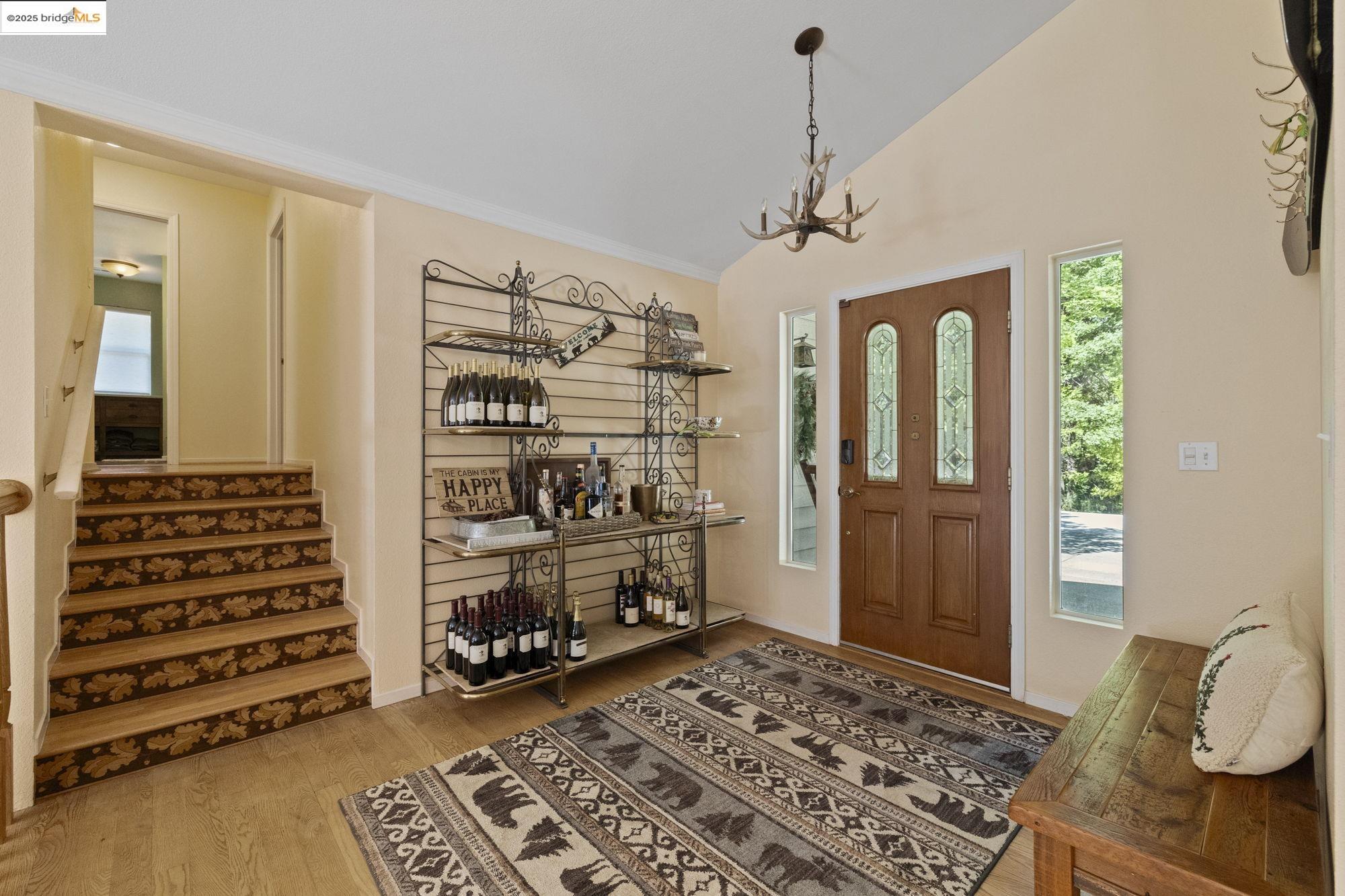 18080 Little Fuller Road Twain Harte, CA 95383 - Photo 5 of 40 Foyer with light wood finished floors, stairway, a chandelier, ornamental molding, and high vaulted ceiling