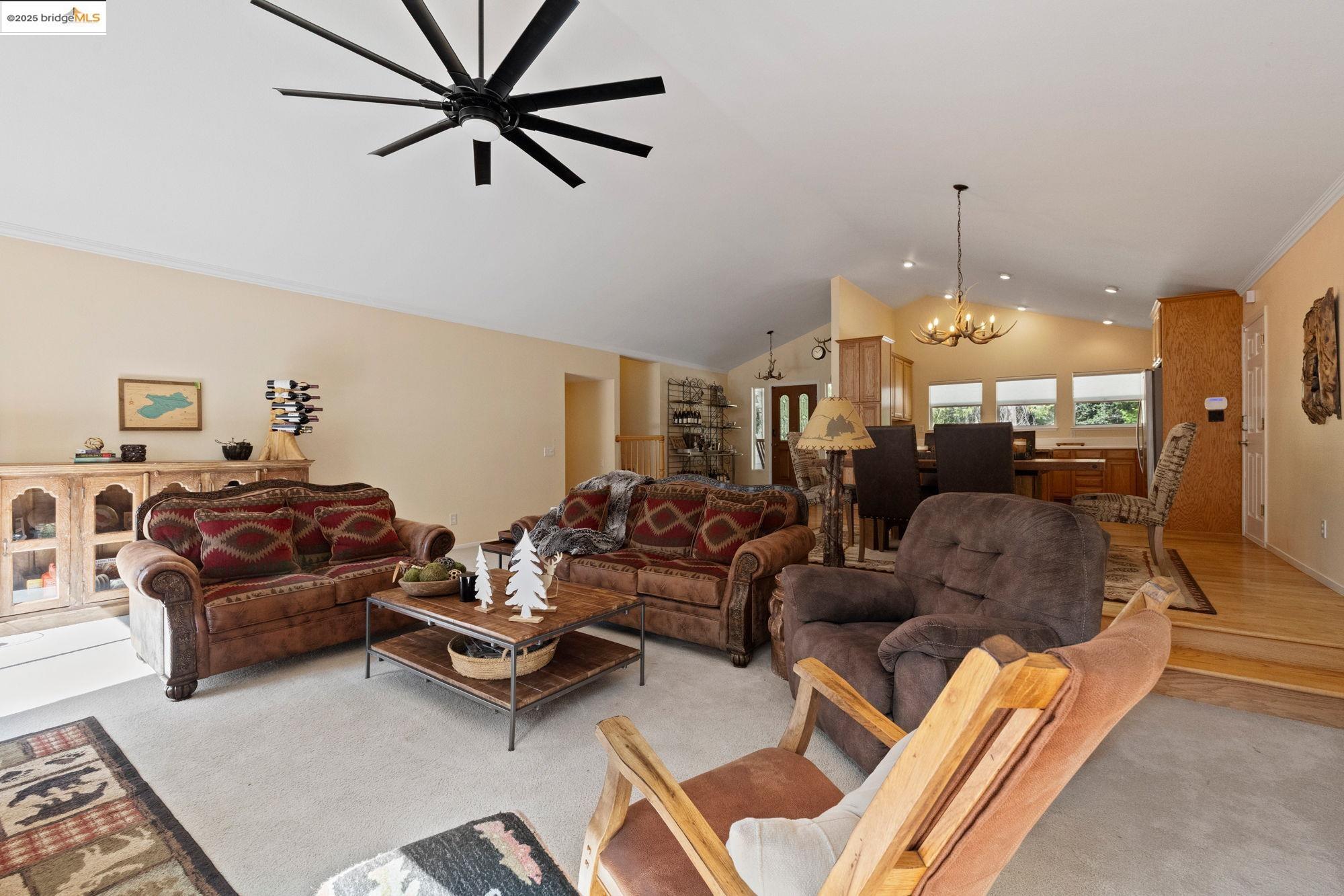 18080 Little Fuller Road Twain Harte, CA 95383 - Photo 8 of 40 Living area with a chandelier, ceiling fan, crown molding, high vaulted ceiling, and wood finished floors