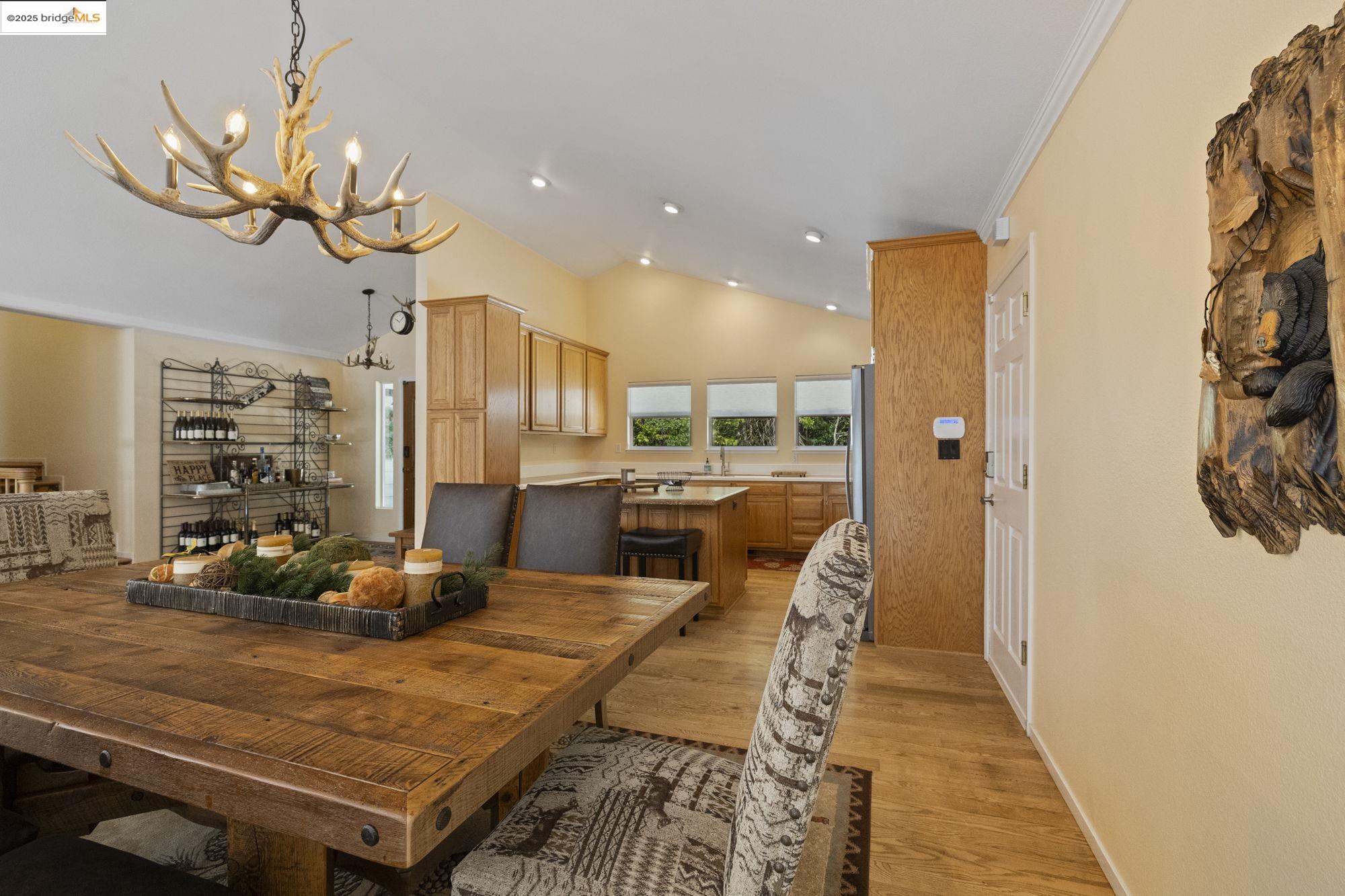 18080 Little Fuller Road Twain Harte, CA 95383 - Photo 10 of 40 Dining area with light wood-style floors, ornamental molding, and high vaulted ceiling