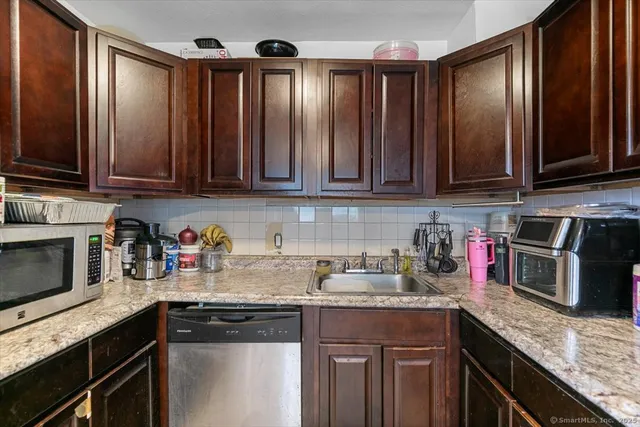 a kitchen with granite countertop stainless steel appliances and cabinets