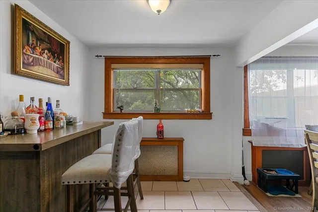 a dining room with a furniture and a window