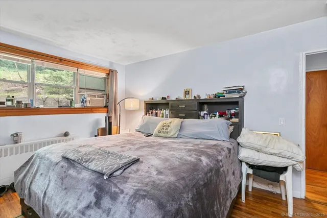 a bedroom with a bed and a large window