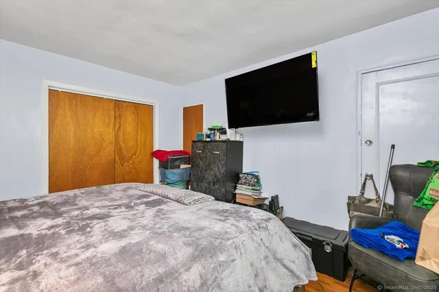a bedroom with a bed and flat screen tv