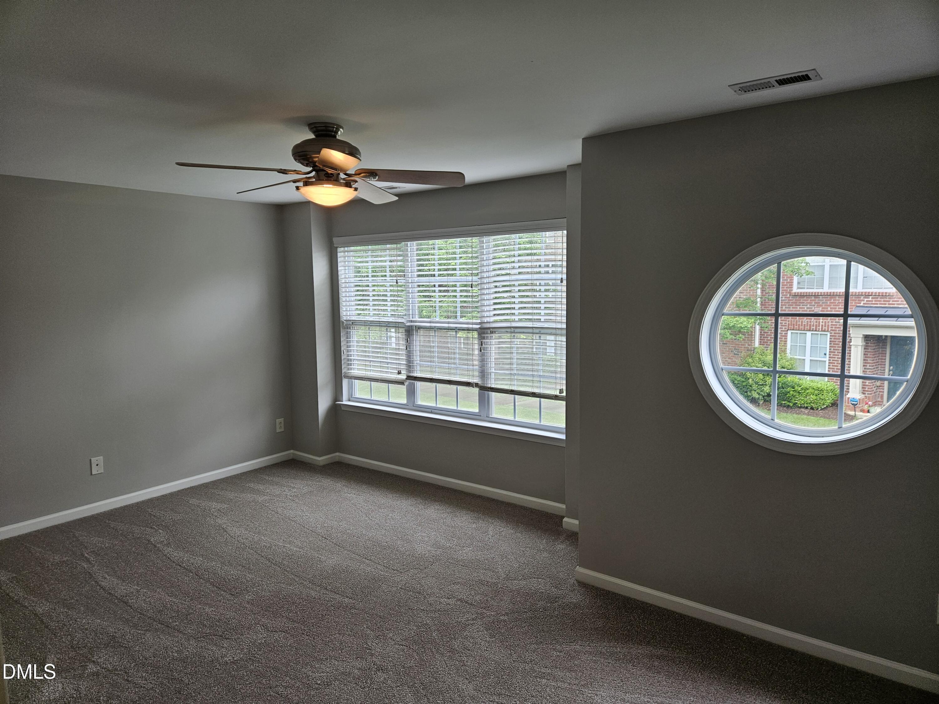 9904 Layla Avenue Raleigh, NC 27617 - Photo 11 of 19 an empty room with windows and fan