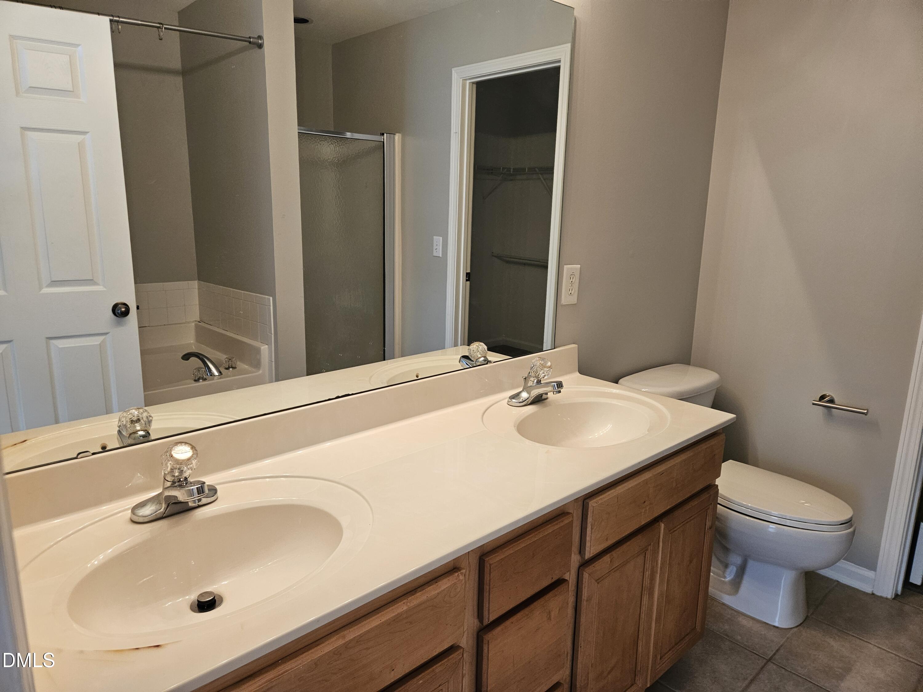 9904 Layla Avenue Raleigh, NC 27617 - Photo 13 of 19 a bathroom with a sink toilet and mirror