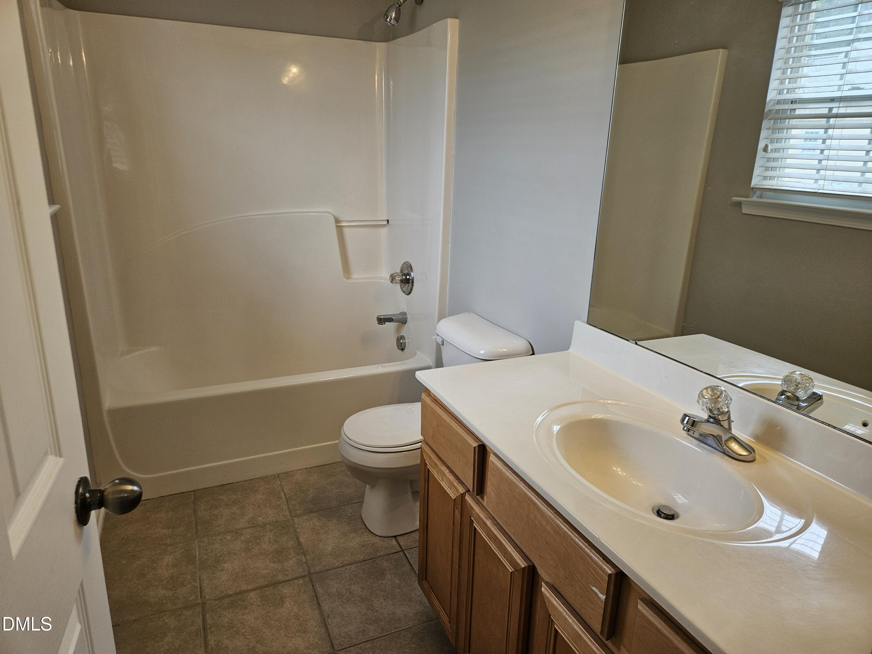 9904 Layla Avenue Raleigh, NC 27617 - Photo 17 of 19 a bathroom with a sink a toilet and shower