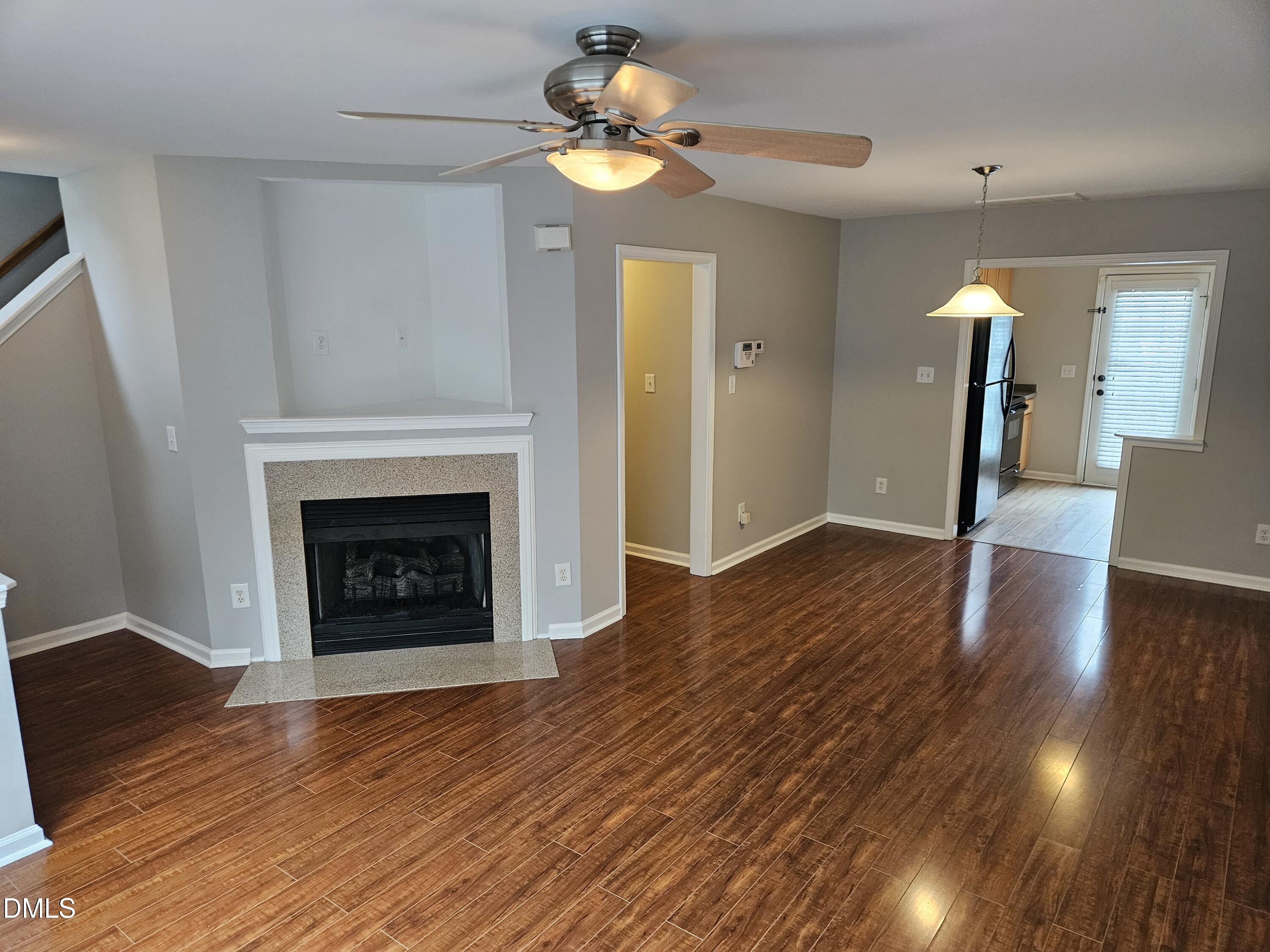 9904 Layla Avenue Raleigh, NC 27617 - Photo 5 of 19 a view of an empty room with wooden floor a fireplace