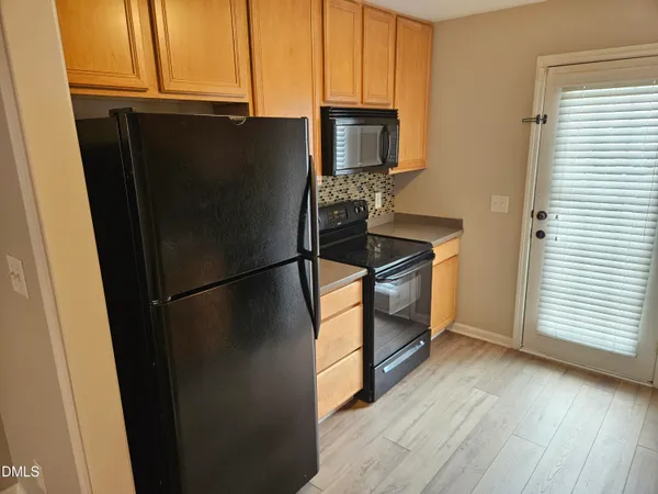 a kitchen with a refrigerator a stove a microwave and cabinets