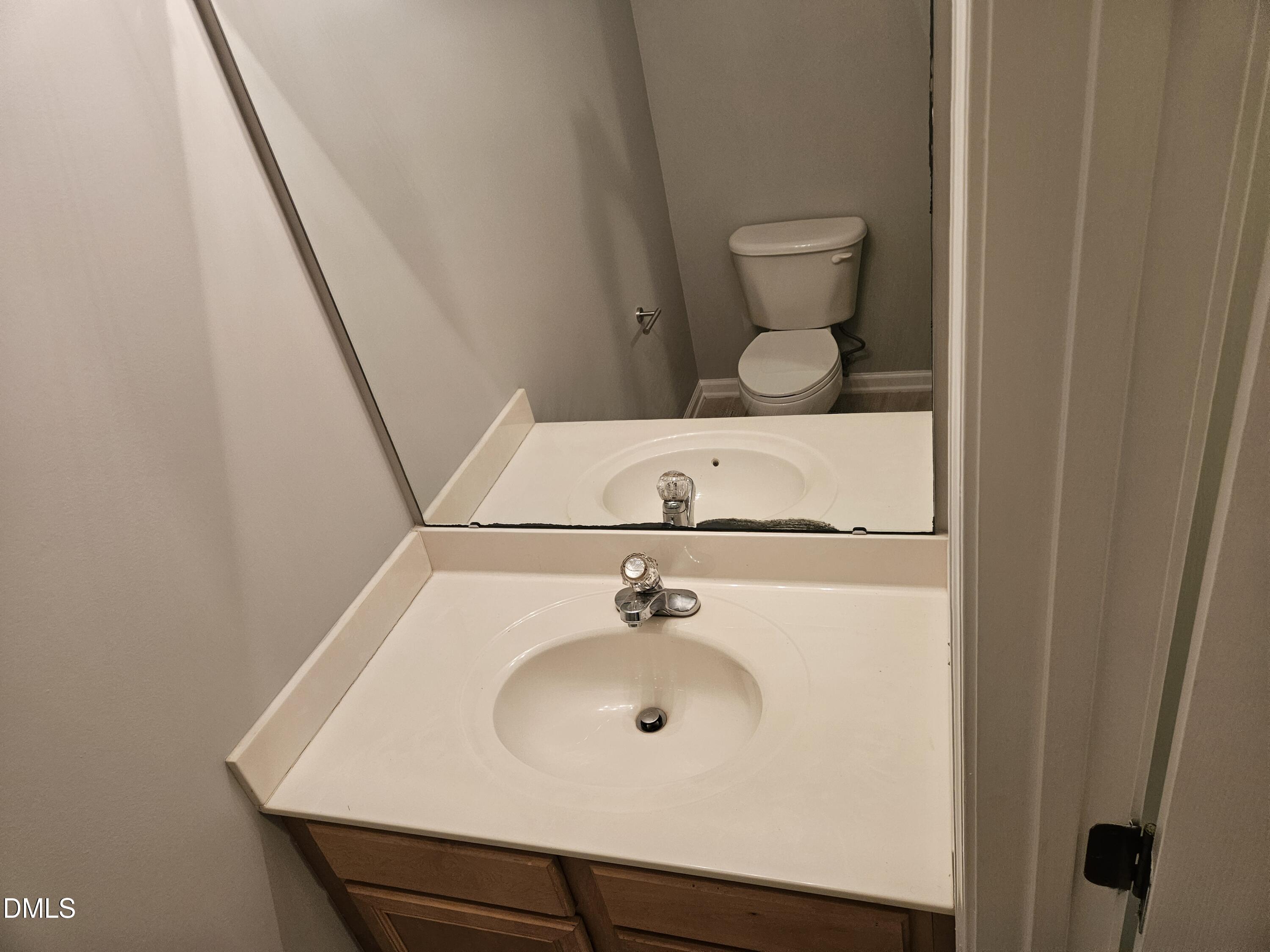 9904 Layla Avenue Raleigh, NC 27617 - Photo 9 of 19 a bathroom with a sink a toilet and mirror