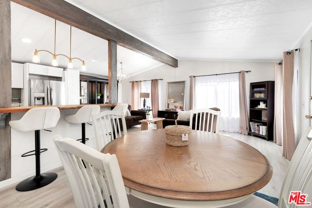 a view of a dining room with furniture and a floor to ceiling window