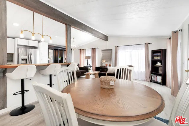 a view of a dining room with furniture and a floor to ceiling window