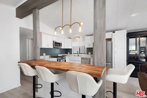 a kitchen with a table chairs and a kitchen