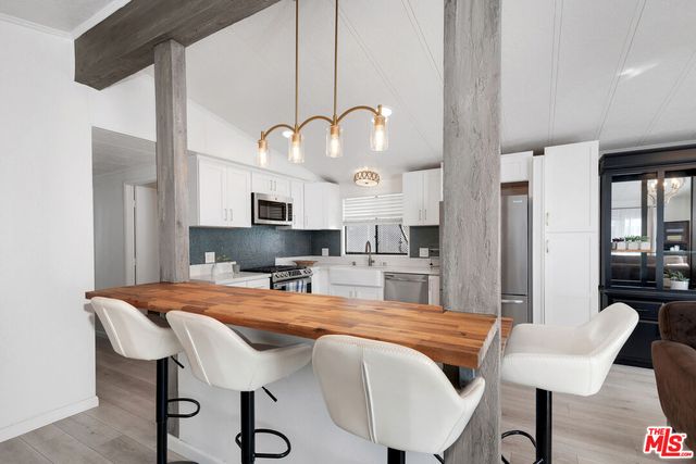 a kitchen with a table chairs and a kitchen