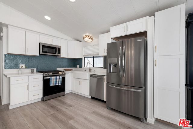 a kitchen with a refrigerator stove and sink