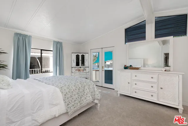 a bedroom with a large bed and a window