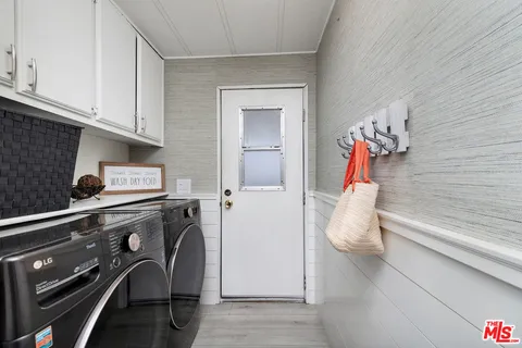 a view of walk in closet with clothes