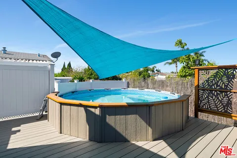 a view of a wooden roof deck with furniture